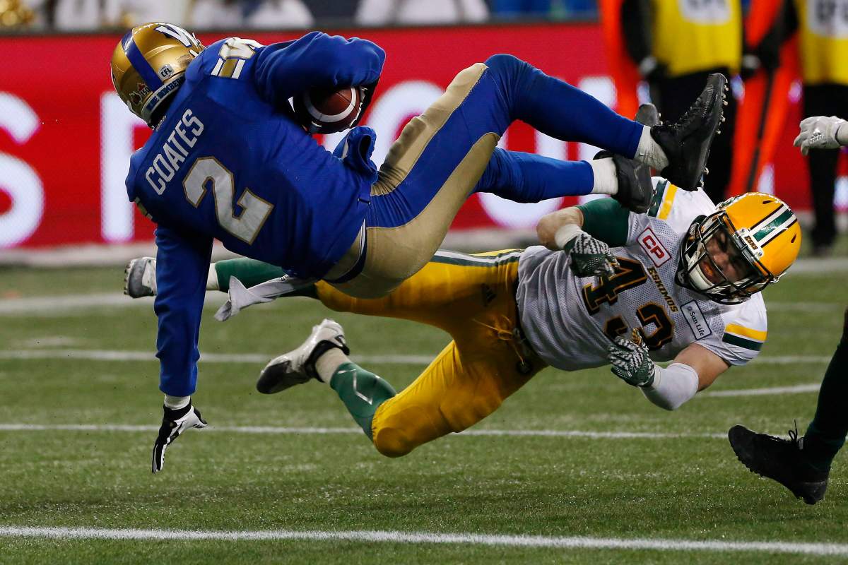 Winnipeg Blue Bombers' Matt Coates (2) makes it across the line for the two points despite getting hit by Edmonton Eskimos' Neil King (43) during second half CFL western semifinal action in Winnipeg on Sunday, November 12, 2017. 
