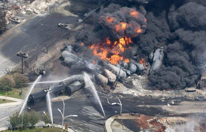 Smoke rises from railway cars that were carrying crude oil after derailing in downtown Lac-Megantic, Que., Saturday, July 6, 2013.