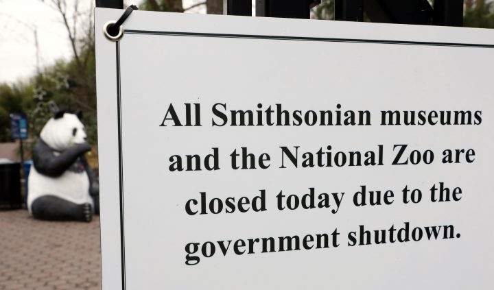 The figure of a panda is seen behind a sign telling the public that the National Zoo is closed due to the partial government shutdown in Washington, D.C., Jan. 2, 2019.