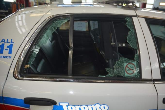 Toronto police vehicle window shot out by Danforth shooter Faisal Hussain.