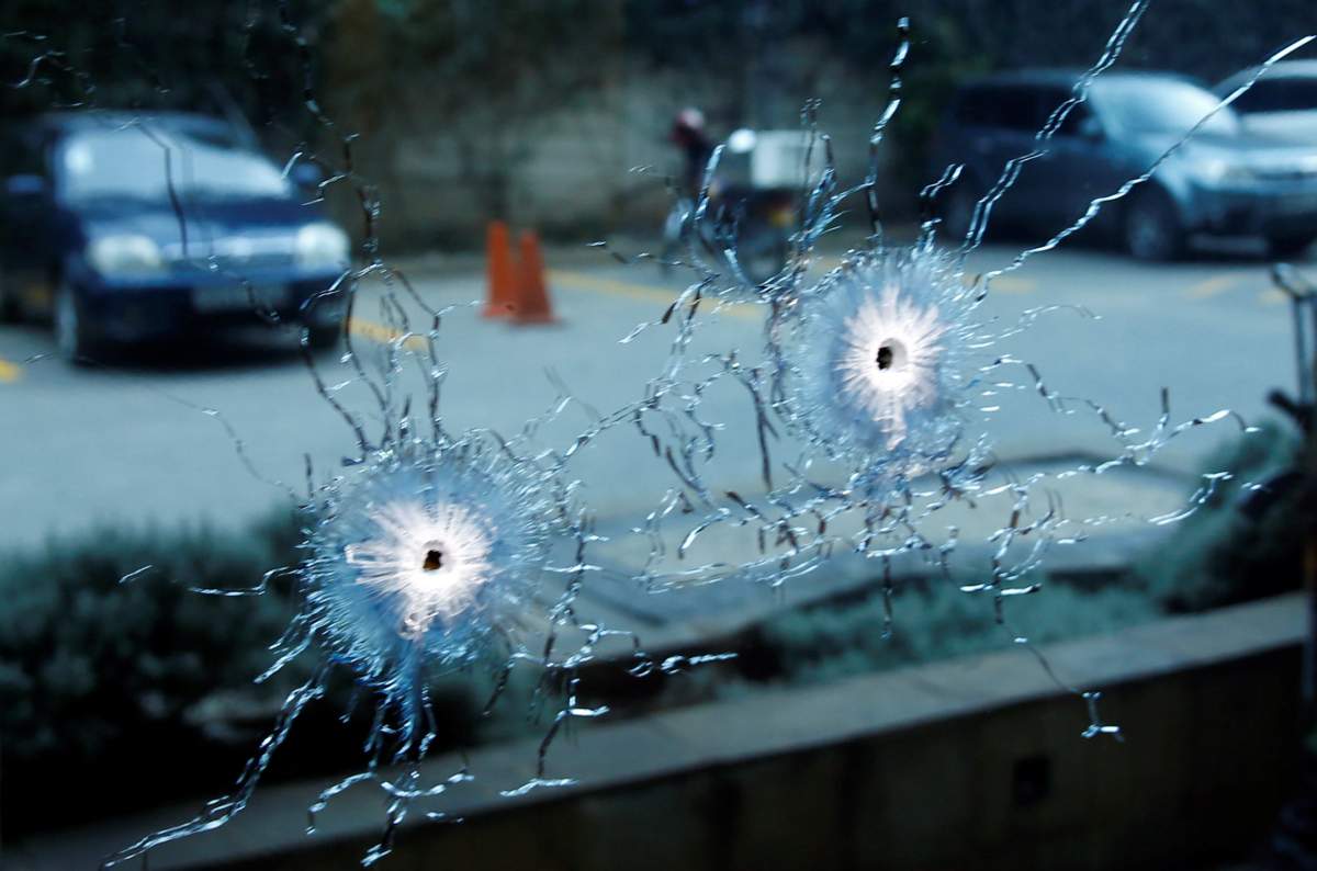 A glass damaged by bullets is seen at the scene where explosions and gunshots were heard at the Dusit hotel compound, in Nairobi, Kenya January 15, 2019. REUTERS/Baz Ratner