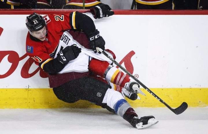 Colorado Avalanche’s Matt Calvert, right, and Calgary Flames’ Garnet Hathaway crash to the ice during second period NHL hockey action in Calgary, Wednesday, Jan. 9, 2019.