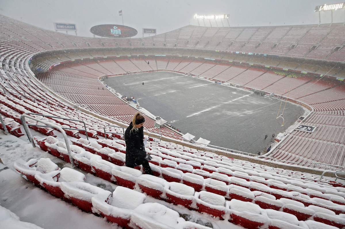 A person walks through the seats in the upper level of stadium in the snow before the Indianapolis Colts and Kansas City Chiefs AFC Divisional Round playoff football game at Arrowhead Stadium in Kansas City, Missouri, USA, Jan. 12, 2019.