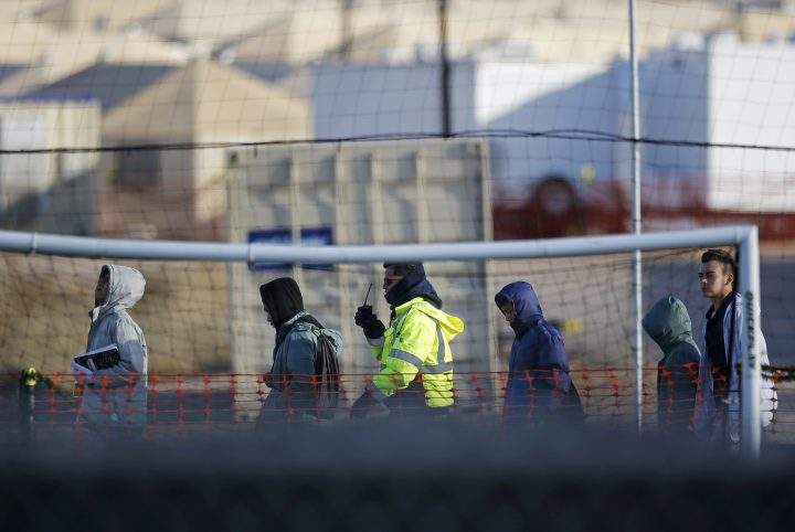 File-In this Dec. 13, 2018, file photo, teen migrants walk in line inside the Tornillo detention camp in Tornillo, Texas.