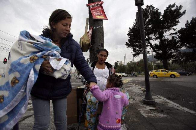 Venezuelan migrants beg for money in Quito, Ecuador, Nov. 22, 2018.