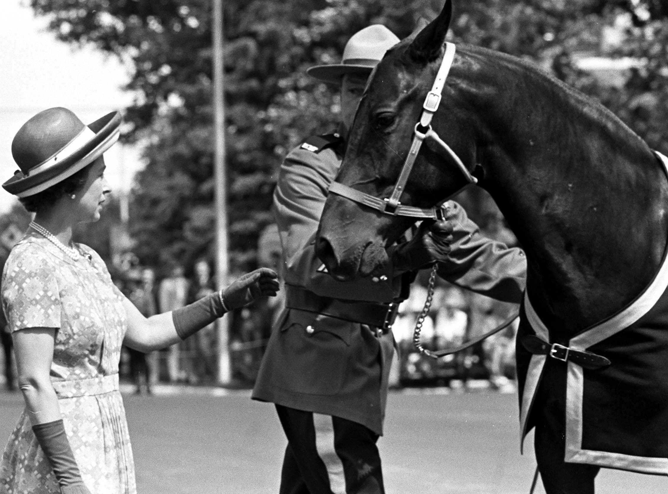 Queen Elizabeth II accepts a gift of one of the RCMP’s horses during a visit to the RCMP Training Depot at Regina, SK., July 4, 1973. Queen Elizabeth II and Prince Philip took part in ceremonies marking the RCMP’s Centennial.