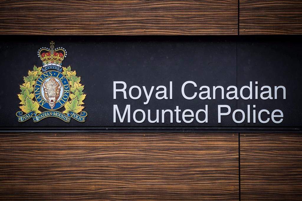 The RCMP logo is seen outside Royal Canadian Mounted Police "E" Division Headquarters, in Surrey, B.C., on Friday April 13, 2018. Nova Scotia's police watchdog says an RCMP constable has been charged with sexual assault and voyeurism after an alleged incident at a party. THE CANADIAN PRESS/Darryl Dyck.