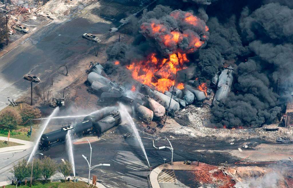 Smoke rises from railway cars that were carrying crude oil after derailing in downtown Lac-Megantic, Que., Saturday, July 6, 2013.