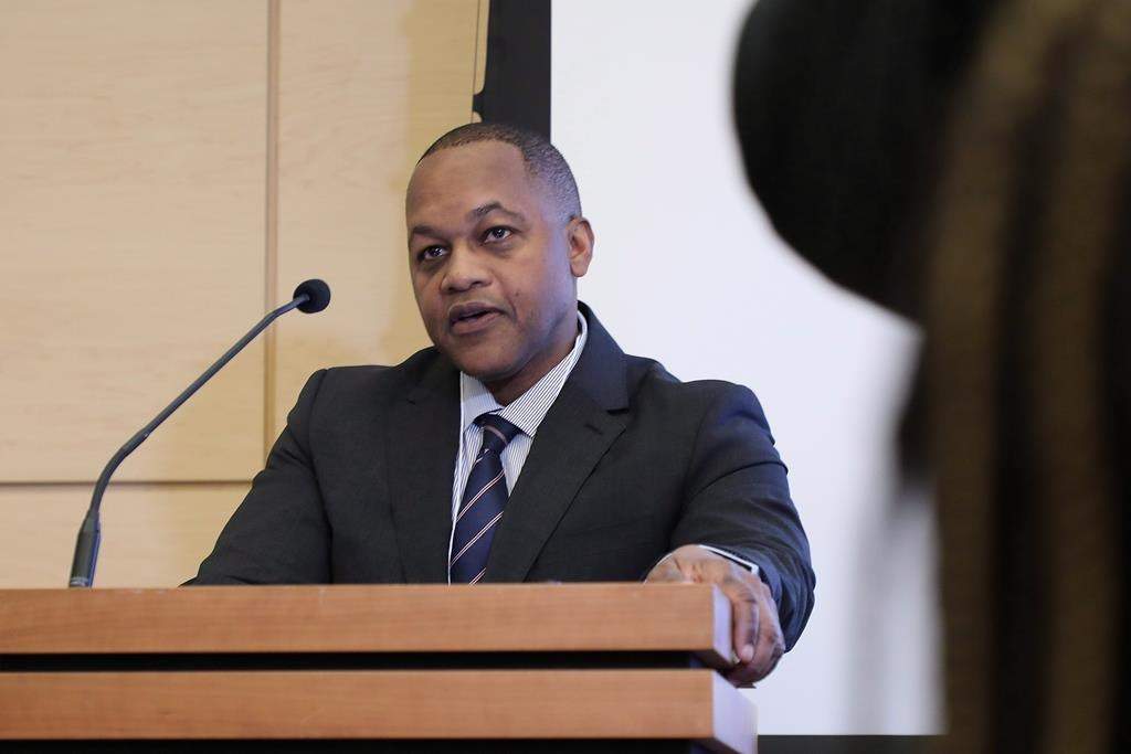 Justice Michael Tulloch speaks at a public meeting on police street checks otherwise known as carding in Toronto on Wednesday, Feb. 28, 2018.