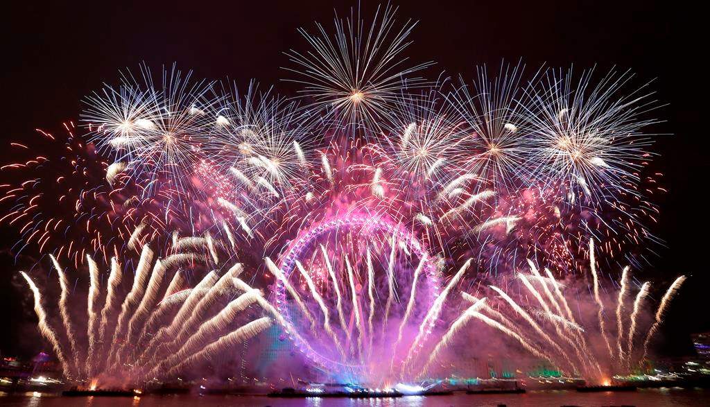 Fireworks explode over the London Eye during the New Year's Eve celebrations after midnight in London, Tuesday, Jan. 1, 2019.