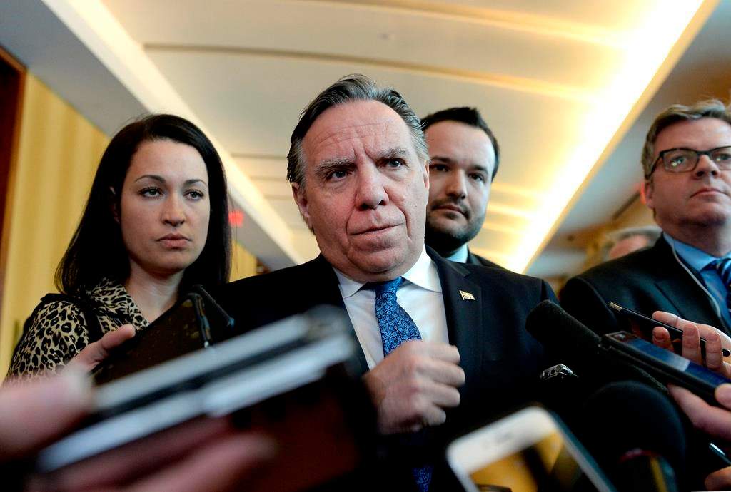 Quebec Premier Francois Legault listens to a questions from reporters before attending a cabinet meeting in Gatineau, Que., on Tuesday, Jan. 29, 2019. The Quebec government has announced it will increase the province's minimum wage but unions believe it's not enough.