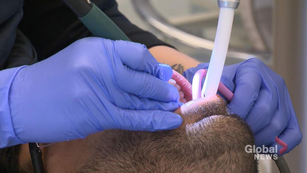 A man undergoes a dental cleaning. 