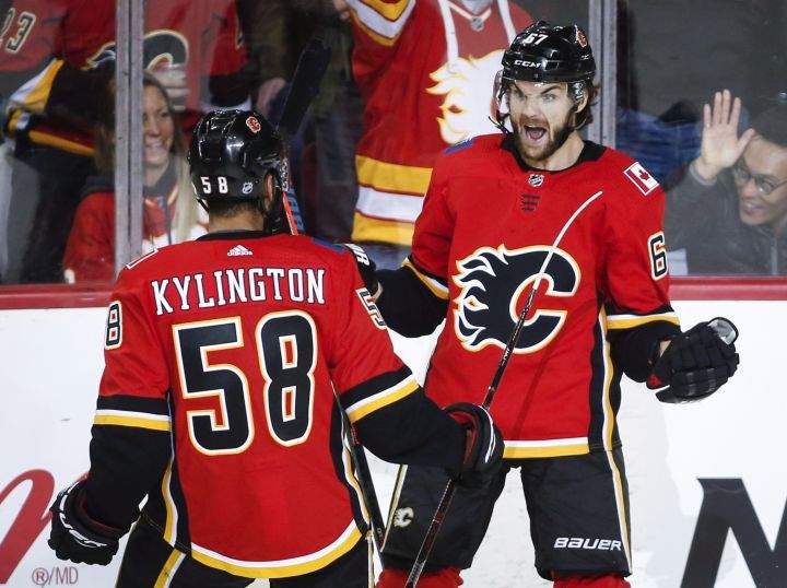 Calgary Flames’ Michael Frolik, right, of the Czech Republic, celebrates his goal with temmate Oliver Kylington, of Sweden, during second period NHL hockey action against the Florida Panthers in Calgary, Friday, Jan. 11, 2019.