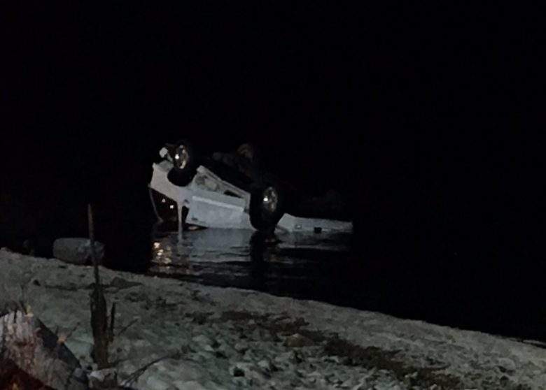 The three occupants of this white vehicle managed to scramble to shore.