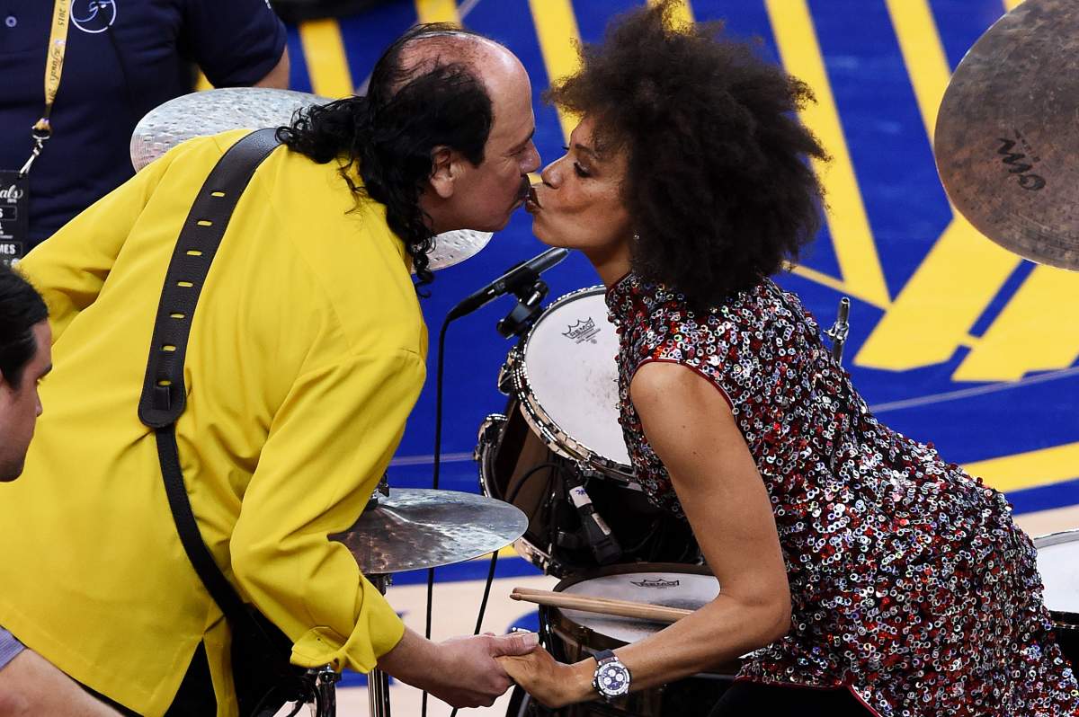 Carlos Santana and his wife Cindy Blackman kiss prior to performing at the 2015 NBA Finals at the Oracle Arena on June 7, 2015, in Oakland, Calif.