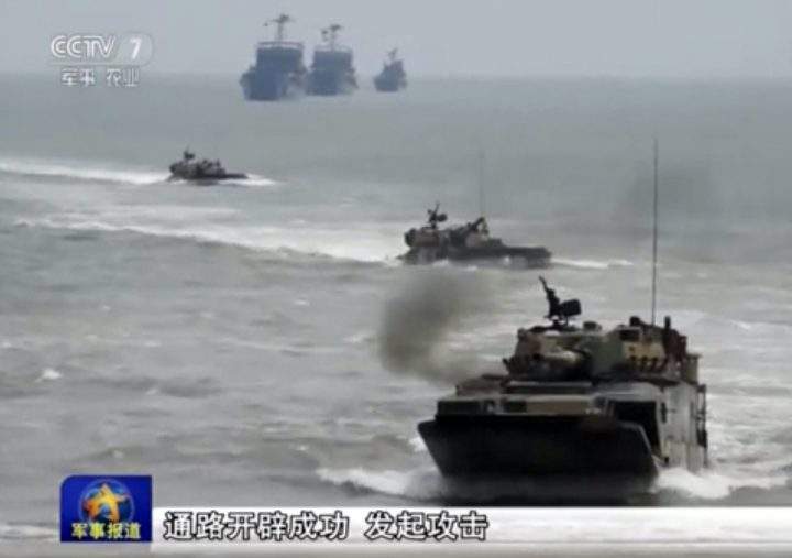 In this image taken from video on May 19, 2016, amphibious assault vehicles from the Chinese People’s Liberation Army participate in a live-firing military drill in Xiamen in southeast China’s Fujian province.
