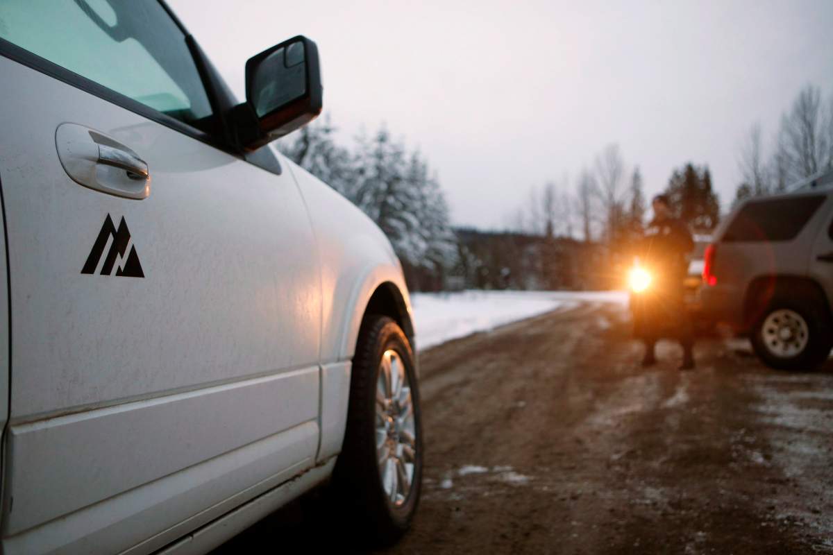An RCMP member looks on as representatives from Coastal GasLink proceed through the exclusion zone at the 27 kilometre marker towards the Unist'ot'en camp to remove barriers on a bridge over the Morice River, southwest of Houston, B.C., on Friday, January 11, 2019.