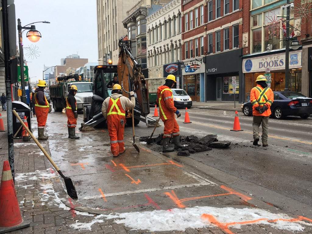 Maintenance crews begin to dig up the pavement of Dundas Street's eastbound lane, to repair a broken watermain on January 15, 2019. 