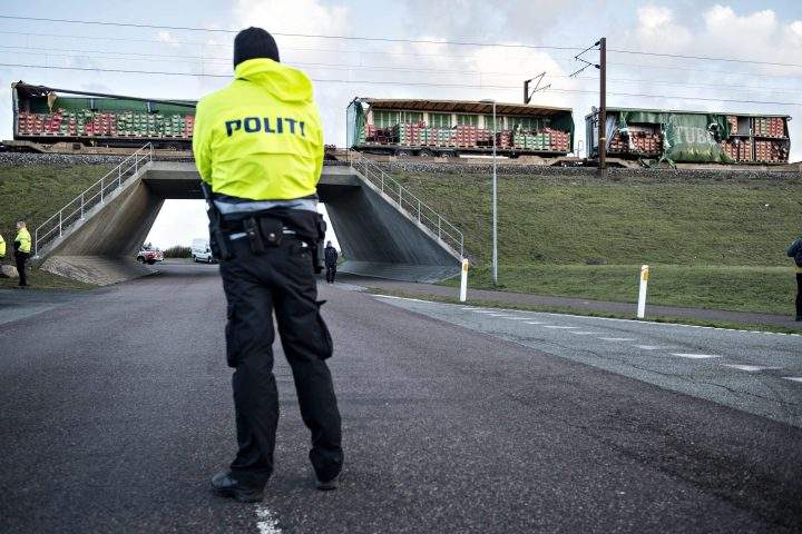 A policeman stands in front of a damaged freight train at the Great Belt Bridge, Denmark, 02 January 2019, after a train accident.