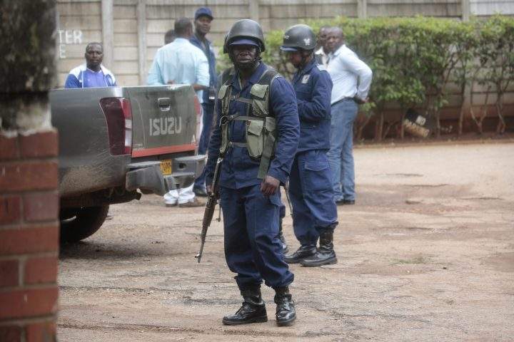 Armed police officers guard outside activist and pastor Evan Mawarire’s house to arrest him in Harare, Zimbabwe, 16 January 2019.