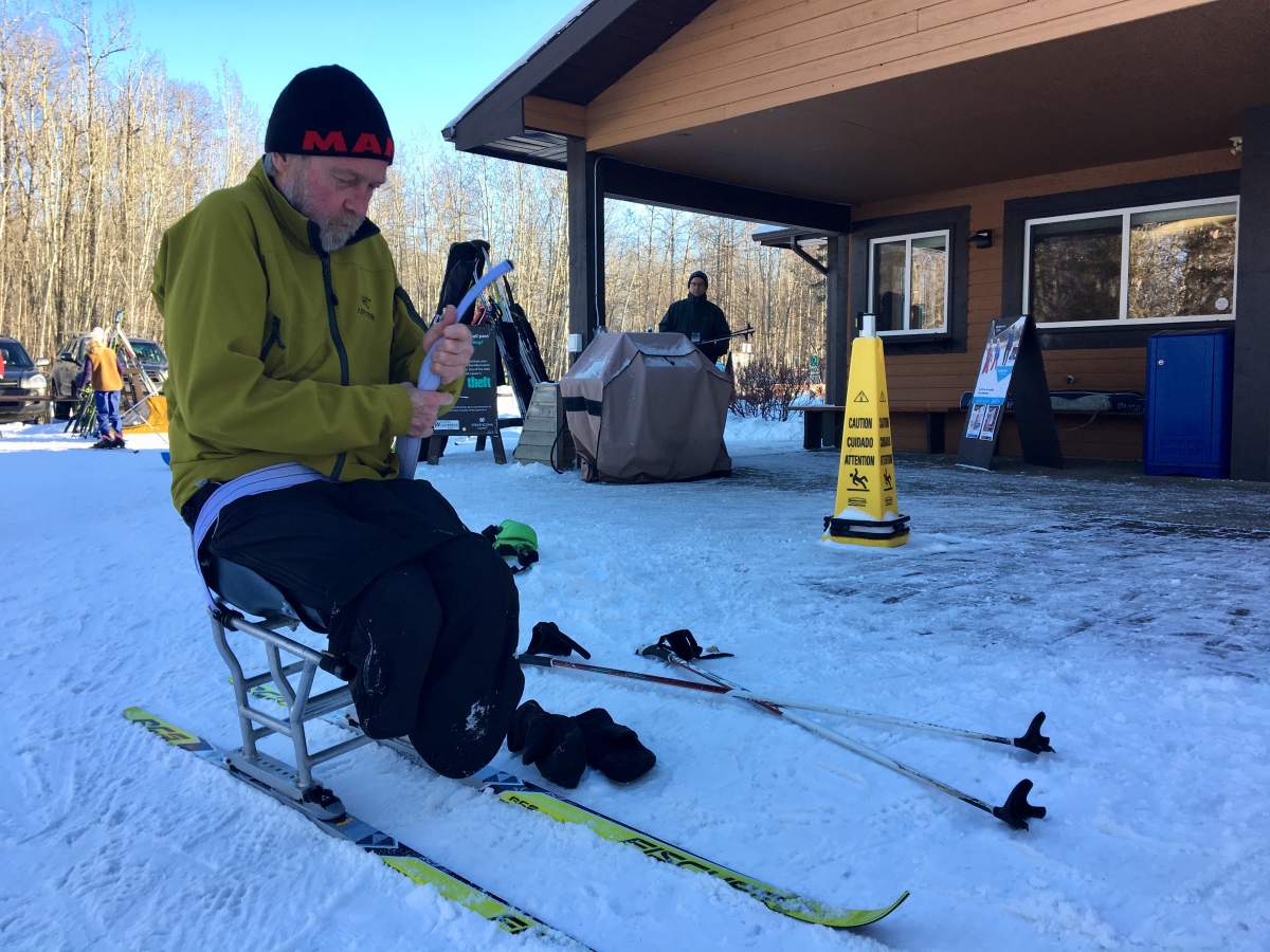 Wouters installs himself in his sit ski ahead of training on Sunday. He had removed the equipment from his SUV before the theft.