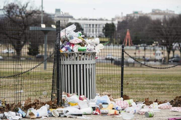 Garbage overflows a trash can on the National Mall across from the White House on Tuesday, Jan. 1, 2019.
