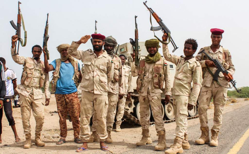 Sudanese soldiers fighting alongside Yemen's Saudi-backed pro-government forces salute beside a road near Al-Jah, Yemen, June 22, 2018.




