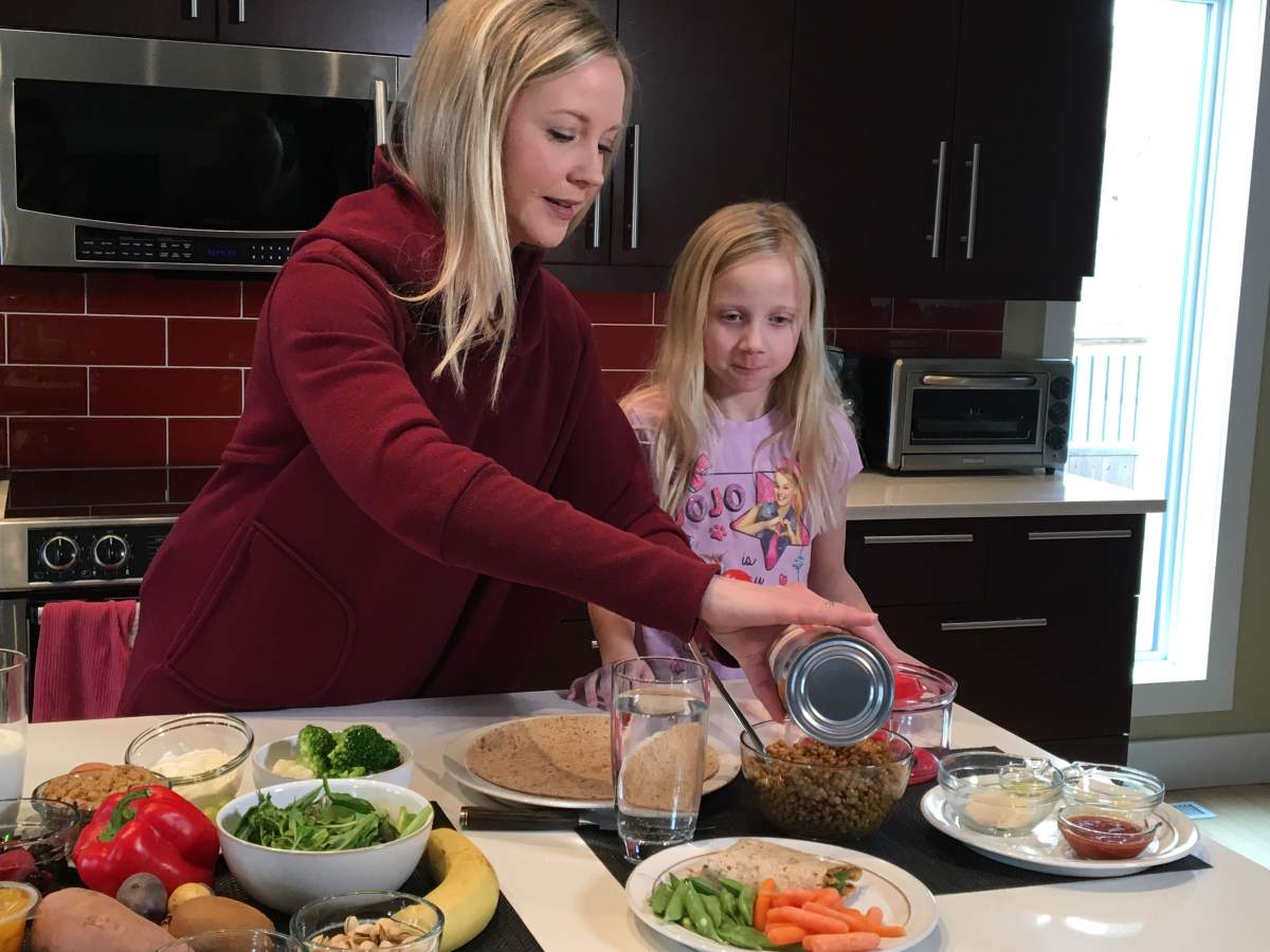 Jorie Janzen and her daughter Alarie making a healthy wrap