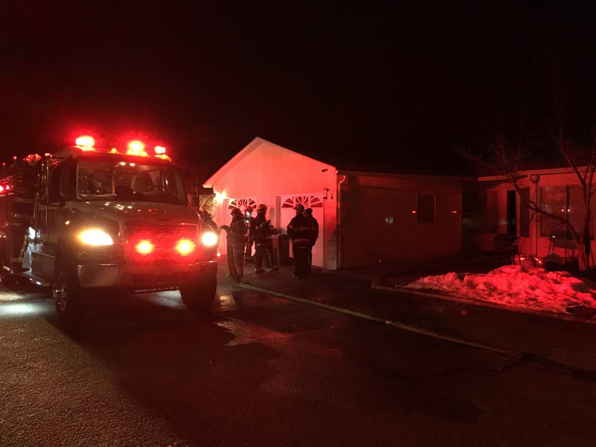 Lake Country fire crews assess damage to a Glenmore Road home after a fire and flood on Monday night. 