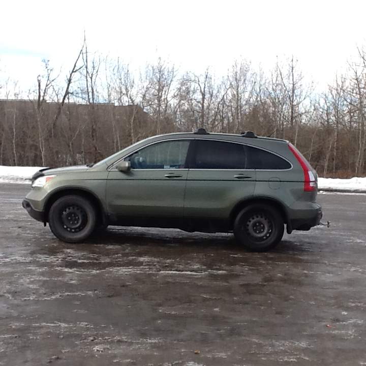 The vehicle is a light green 2009 Honda CR-V with the Alberta licence plate 48-M554.