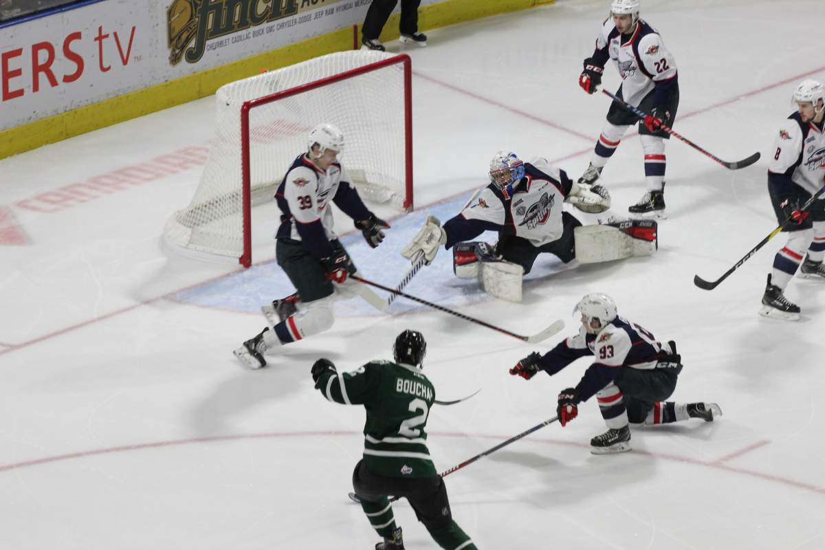 Knights captain Evan Bouchard puts the puck past Kari Piiroinen in the second period of London’s win over Windsor.