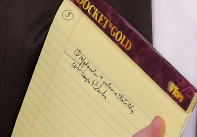 A zoomed-in image of a notepad held by U.S. National Security Adviser John Bolton appears to say “5,000 troops to Colombia.”
