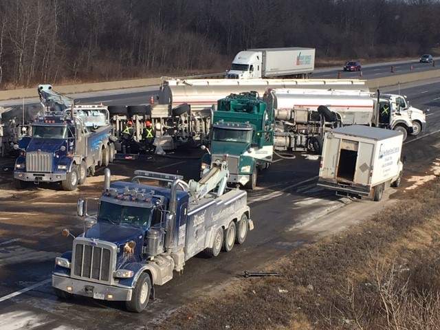 Crews cleaning up jet fuel after a tanker truck overturned on Highway 401 near Cambridge on Sunday.