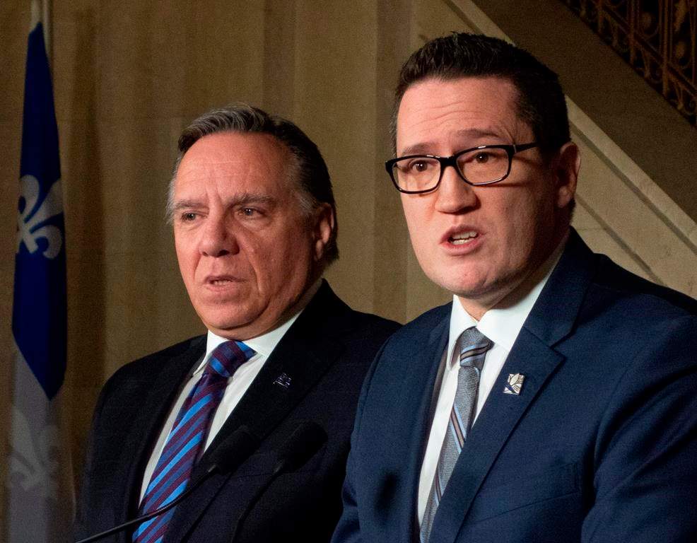 The newly appointed minister Benoit Charette, right, is pictured next to Quebec Premier Legault. Legault and his cabinet have continuously denied to acknowledge that systemic racism exists in the province.