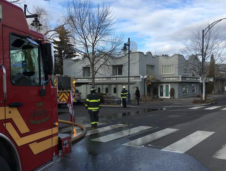Smoke can be seen from the second floor of the building that houses Pope’s Photography Studio on Pandosy Street.