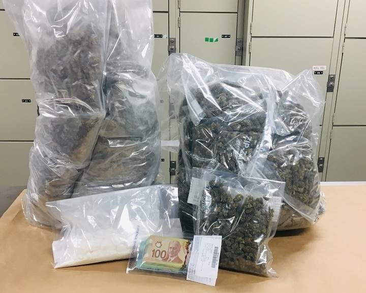 Marijuana, cocaine, money and a taser are displayed by Kelowna RCMP after police executed a search warrant in June.