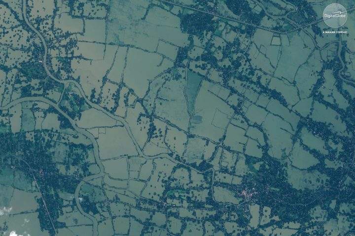 This Aug. 22, 2018 satellite image provided by DigitalGlobe shows flooded fields and villages in Kerala, India.