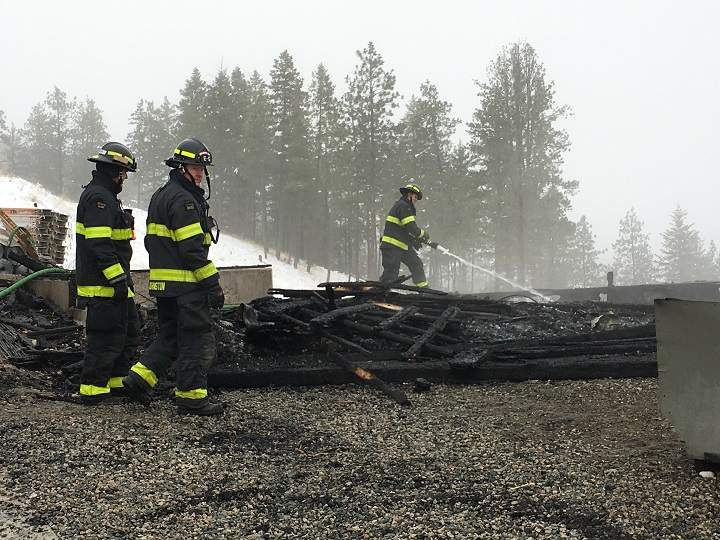 Firefighters investigate the ruins of the under-construction house that was destroyed by fire early Thursday.