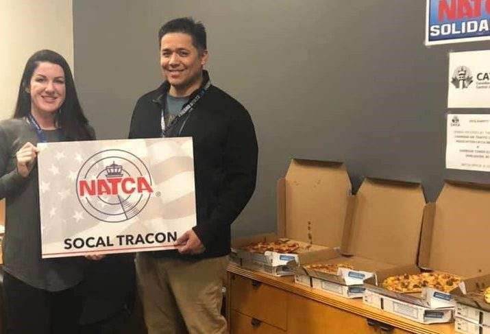 Employees show off their pizza haul in the US from Winnipeg.