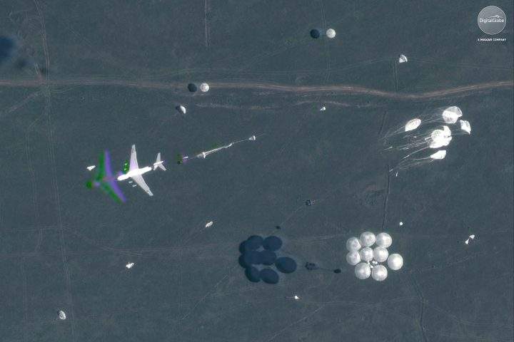 This Sept. 13, 2018 satellite image provided by DigitalGlobe shows an airborne paradrop during the Vostok military exercises in the Eastern Siberia area of Russia.