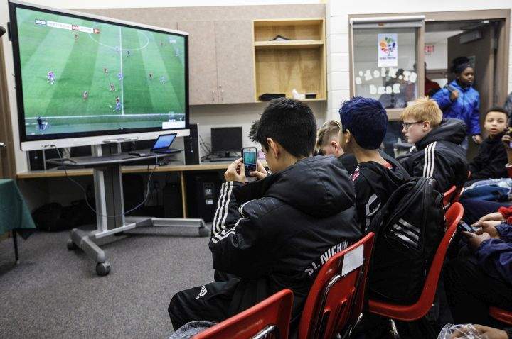 Students at St. Nicholas Catholic Junior High School watch the FC Bayern Munich vs TSG 1899 Hoffenheim on tv in Edmonton, Alta., on Friday January 18, 2019. Former Nicholas Catholic Junior High student, Alphonso Davies joined Bayern Munich in the new year, following a $22-million transfer from the Vancouver Whitecaps.