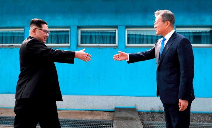 In this April 27, 2018, file photo, North Korean Leader Kim Jong Un, left, prepares to shake hands with South Korean President Moon Jae-in over the military demarcation line at the border village of Panmunjom in Demilitarized Zone.