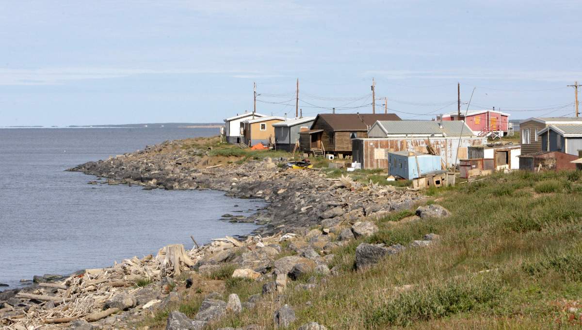 This photo taken Saturday, Aug. 8, 2009, shows the hamlet of Tuktoyaktuk in the Northwest Territories, Canada. Seas rising from global warming and land sinking as permafrost thaws are threatening the Arctic community.