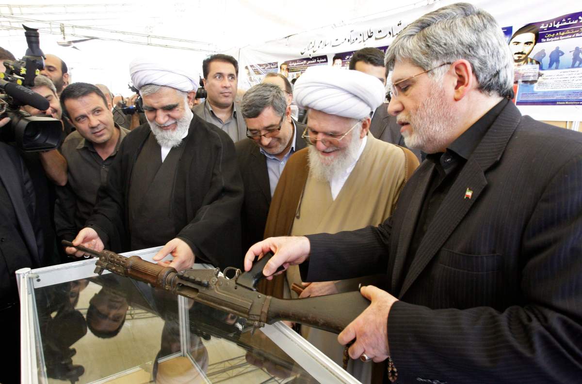 ABWA Secretary-General Mohammad Hasan Akhtari, the “operational father” of Hezbollah, looking at a rifle allegedly seized from Israeli soldiers by Hezbollah fighters during the 2006 Lebanon war, Saturday, Aug. 11, 2012. The CRA alleges the Islamic Shia Assembly of Canada invited him to Toronto. (AP Photo/Vahid Salemi)