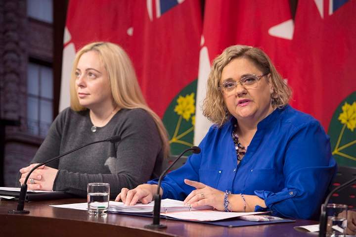 Laura Kirby-McIntosh (right), president of the Ontario Autism Coalition, speaks as autism parent Maria Galito listens in at a news conference at the Ontario Legislature in Toronto on Monday, November 12, 2018. THE CANADIAN PRESS/Frank Gunn.