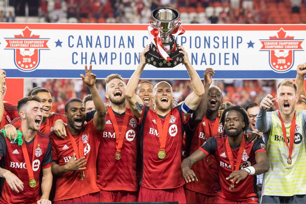 Toronto FC captain Michael Bradley lifts the Voyageurs Cup after beating Vancouver Whitecaps 5-2 to win the Canadian Championship Final, in Toronto on Wednesday, August 15, 2018. 