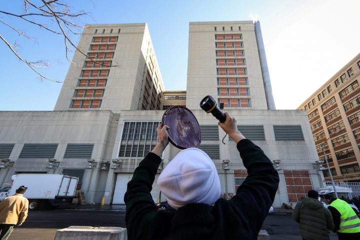 A demonstrators bangs on a piece of metal to communicate with prisoners inside the Brooklyn Metropolitan Detention Center, following a bomb threat in the Brooklyn borough of New York, U.S., Feb. 4, 2019.