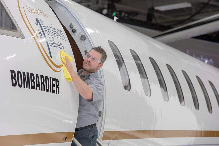 IN this Dec. 2018 file photo, Francis Masse shines up Bombardier's new jetliner, the Global 7500, the longest-range business jet in the world at the company's finishing plant in Montreal.