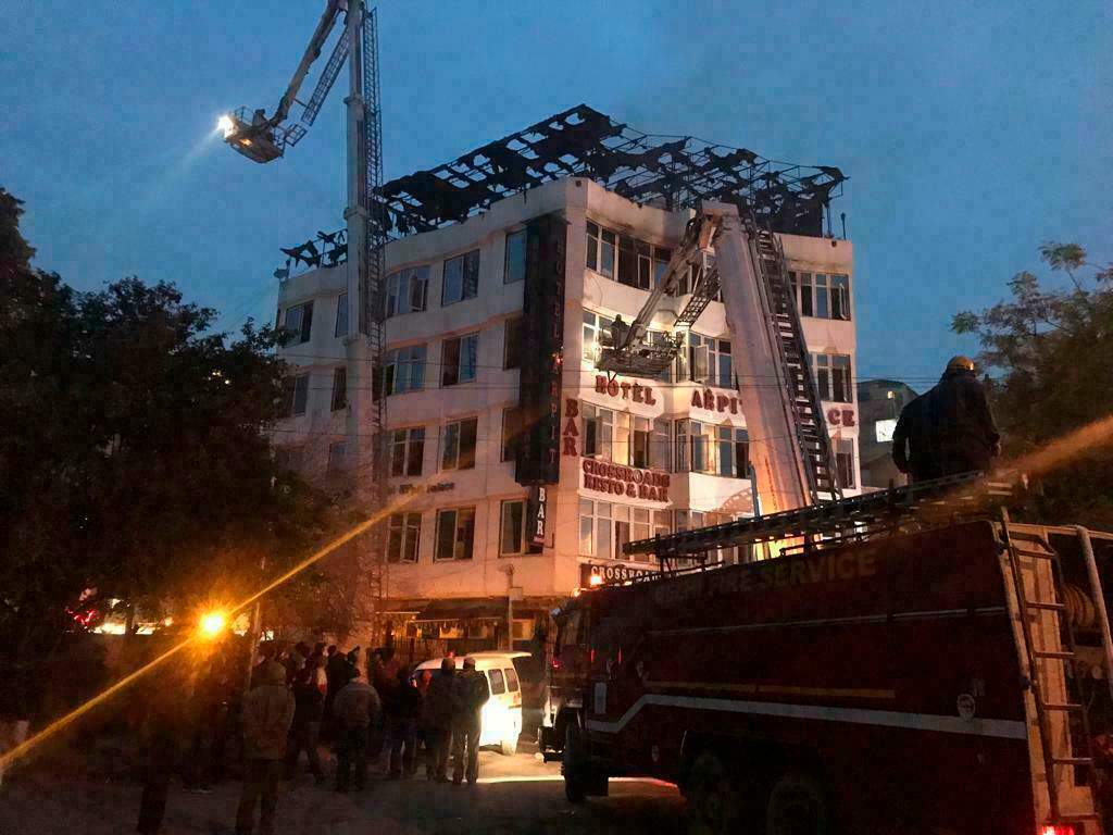S hotel guest who was rescued, firefighters rescue people during an early morning fire at the Arpit Palace Hotel in the Karol Bagh neighborhood of New Delhi.