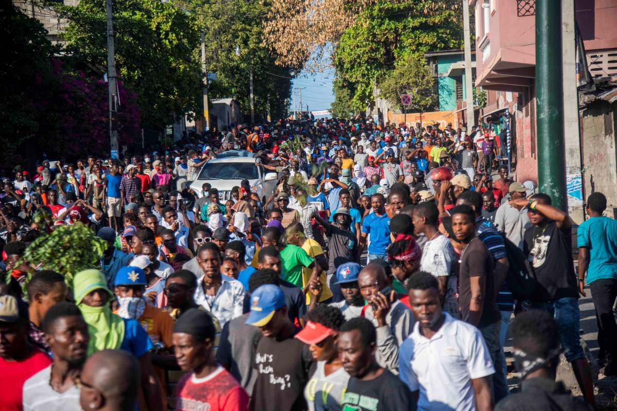 People march during a protest in Port-au-Prince, Haiti, on Feb. 13, 2019. The political crisis in Haiti is aggravated by a week of violent protests calling for the resignation of President Jovenel Moise, which has left at least nine dead.  